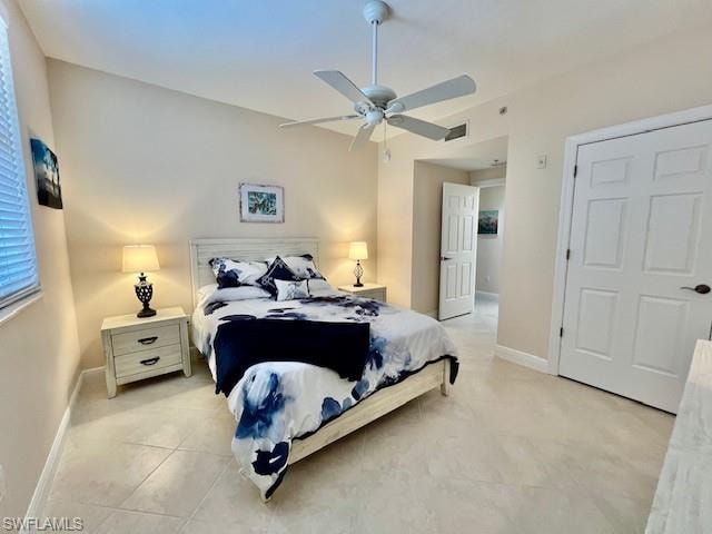 Bedroom featuring light tile patterned floors, visible vents, baseboards, and a ceiling fan