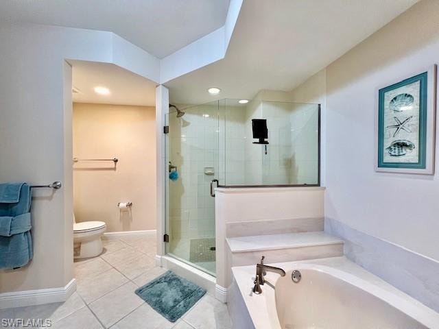 Full bath featuring tile patterned flooring, baseboards, toilet, a garden tub, and a stall shower