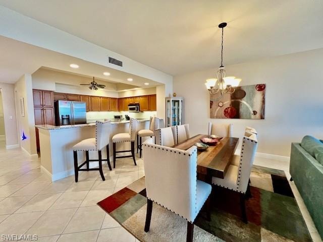 Dining area with visible vents, baseboards, recessed lighting, light tile patterned flooring, and a notable chandelier