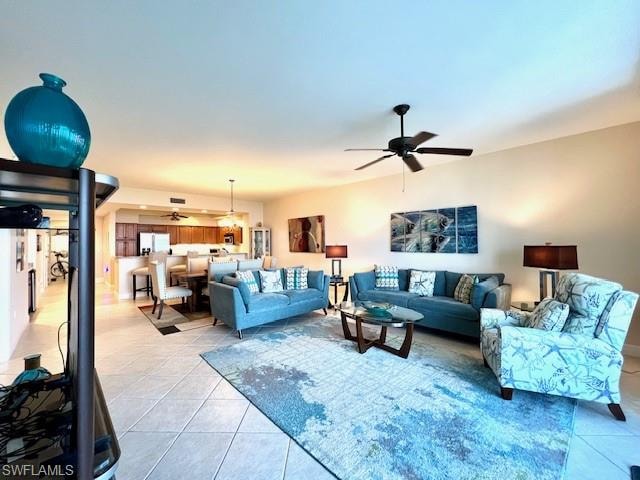 Living area with light tile patterned flooring and a ceiling fan