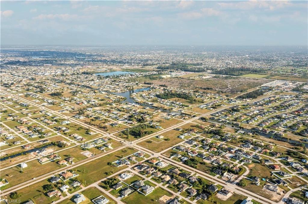 Birds eye view of property with a water view