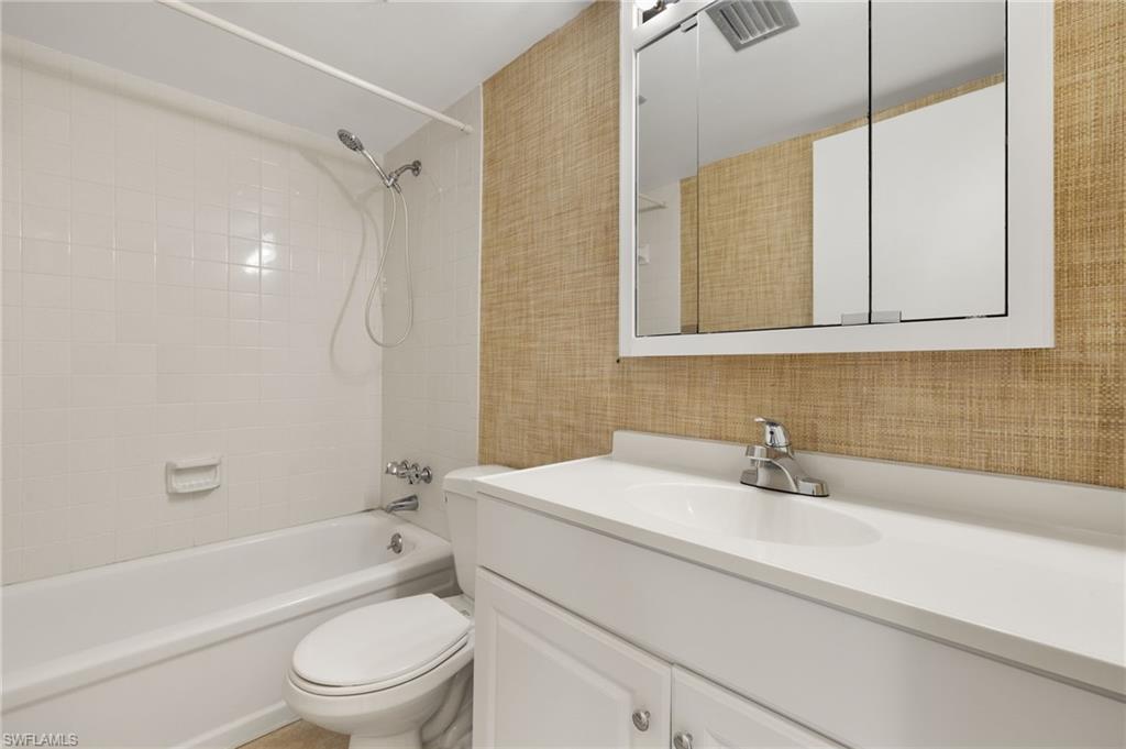 Full bath with vanity, toilet, washtub / shower combination, and visible vents