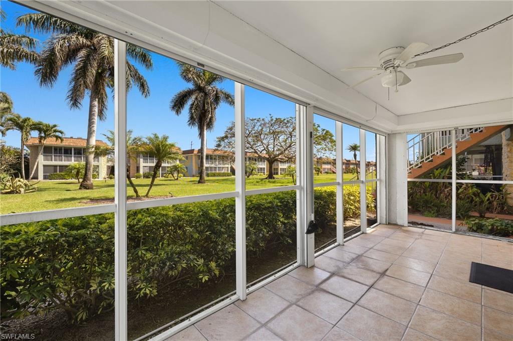 Unfurnished sunroom featuring ceiling fan