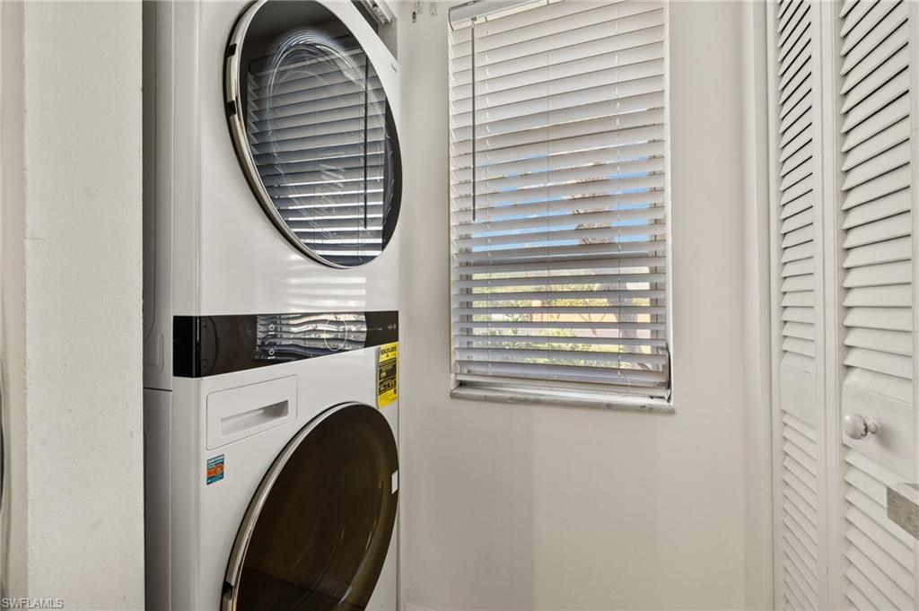 Laundry room with laundry area and stacked washing maching and dryer