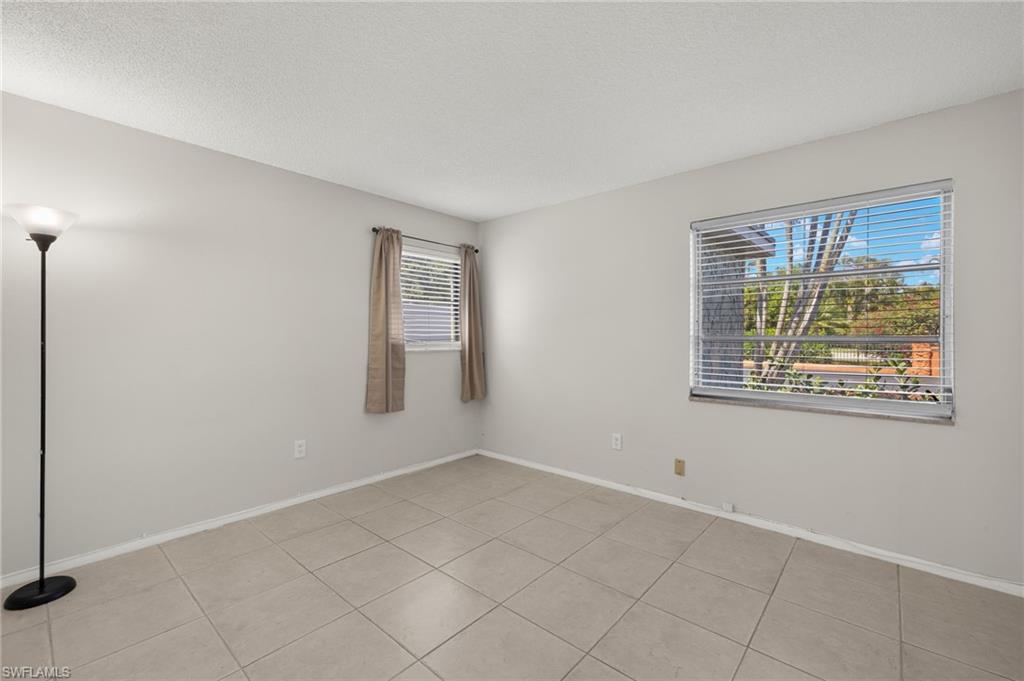 Unfurnished room featuring baseboards and a textured ceiling