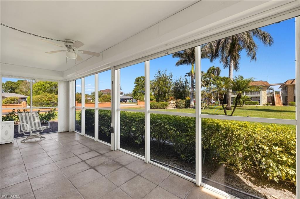 Unfurnished sunroom with ceiling fan