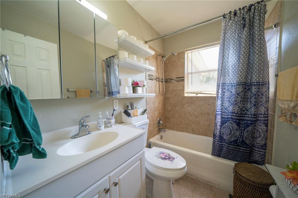 Full bathroom featuring vanity, tile patterned floors, toilet, and shower / bath combo