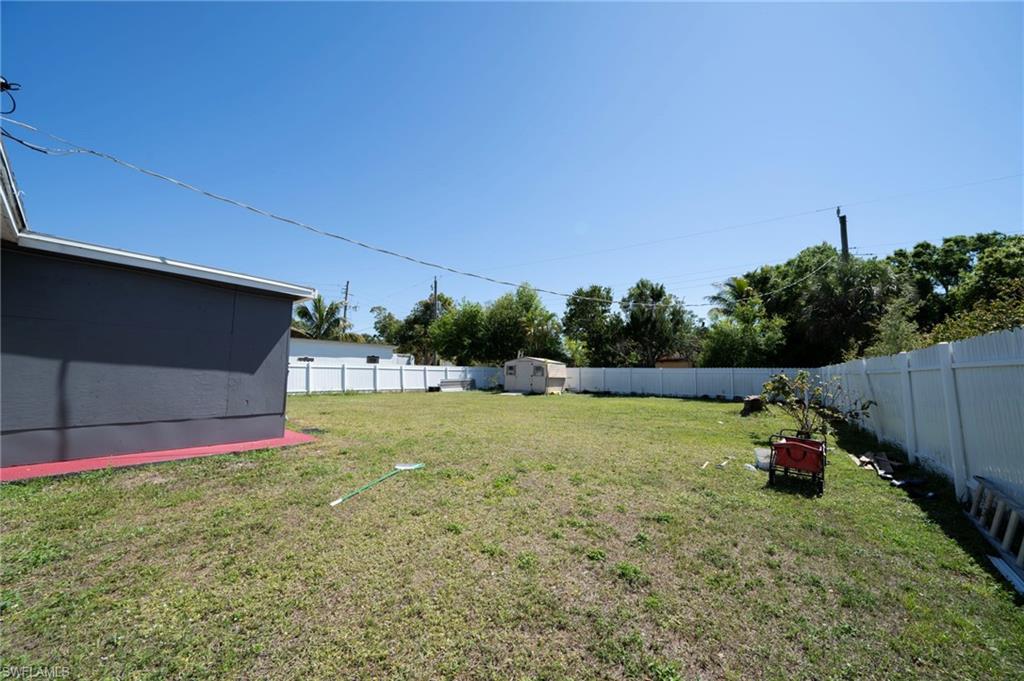 View of yard with an outbuilding, a fenced backyard, and a shed