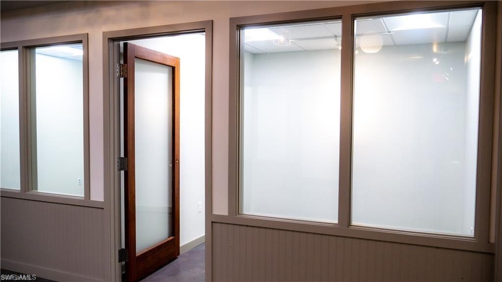 Hallway featuring a drop ceiling