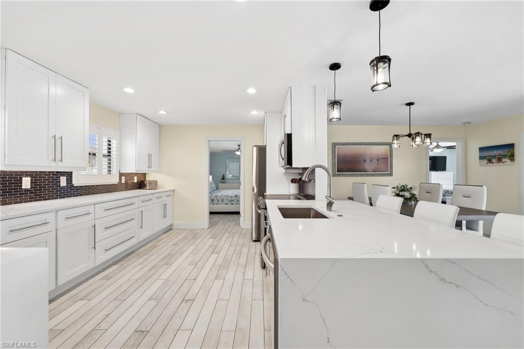 Beautiful Tile Backsplash and Quartz Countertop with Waterfall Edge
