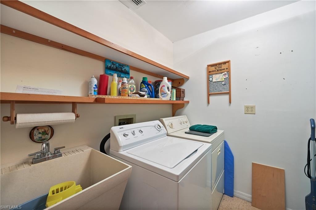 Laundry area with washing machine and dryer and baseboards