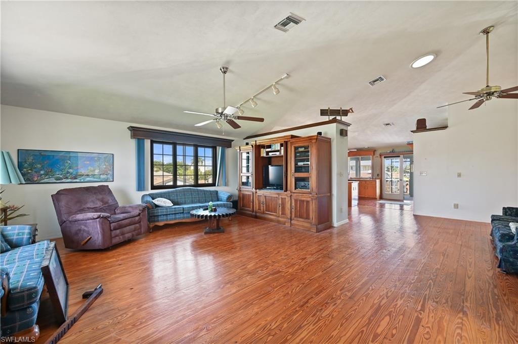 Living area featuring ceiling fan and wood finished floors