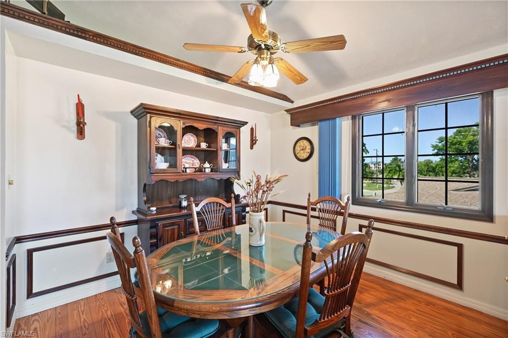 Dining area with light wood-type flooring and a ceiling fan