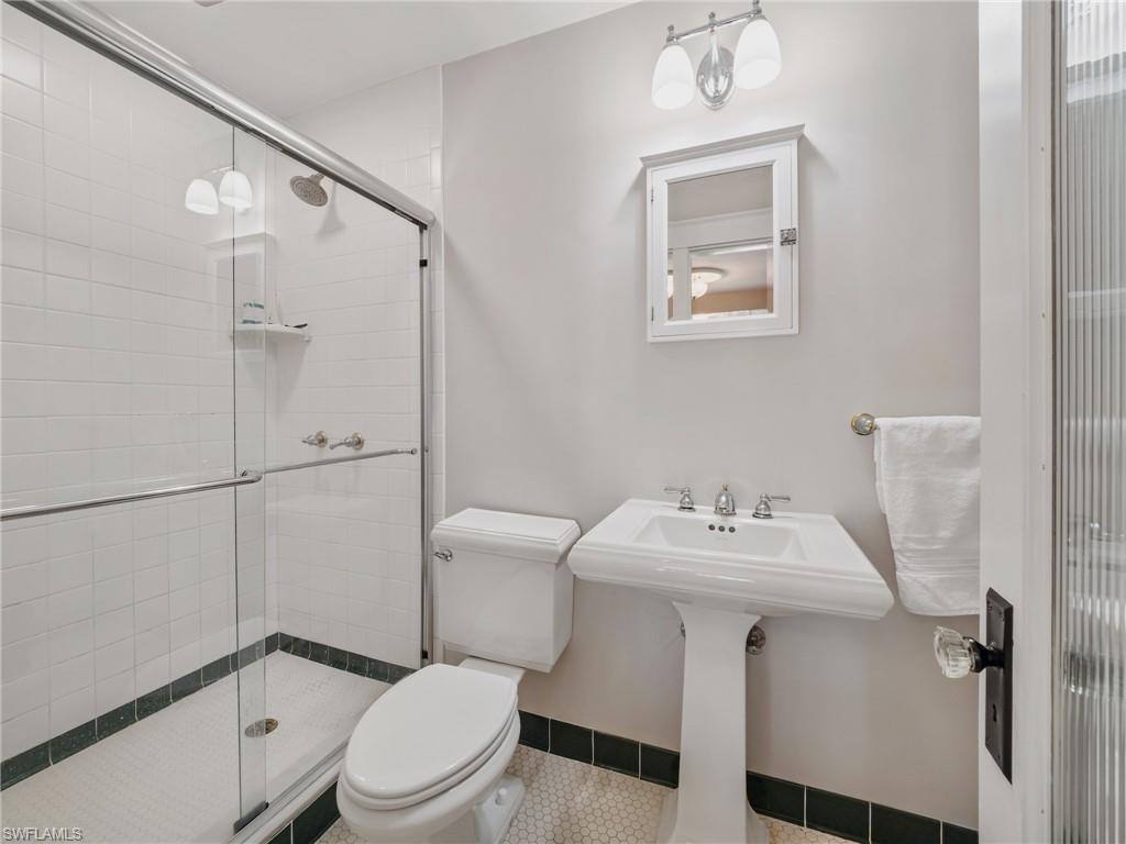 Classic charm meets practicality in this well-appointed downstairs bathroom, offering easy access from the home's main living spaces.