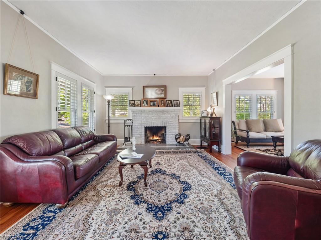 High ceilings, natural light, original hardwood flooring, and a working wood-burning fireplace create an atmosphere that feels both grand and inviting.