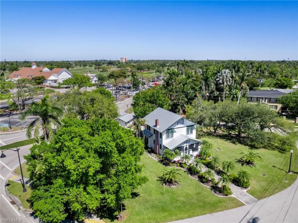 Aerial views showcase the home's impressive setting on its own historic block, surrounded by mature trees, charming architecture, and the character that defines Old Fort Myers.