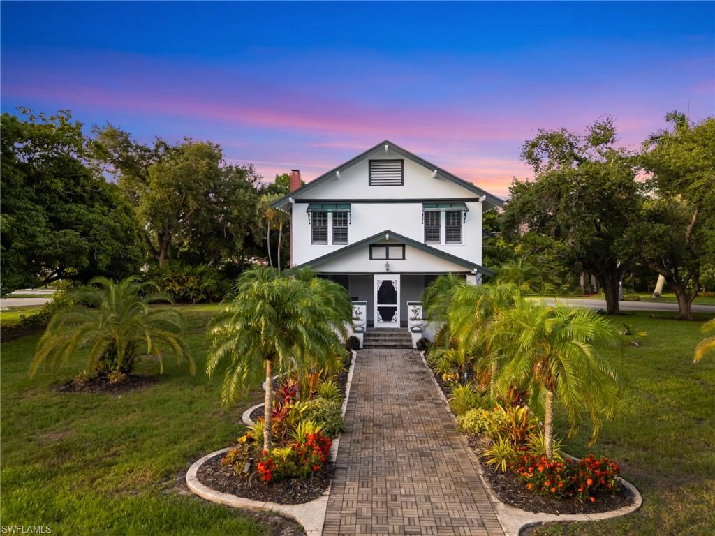 A picture-perfect arrival. Towering palms frame the stately Colonial facade, creating a timeless entrance that feels as welcoming today as it did in 1925.