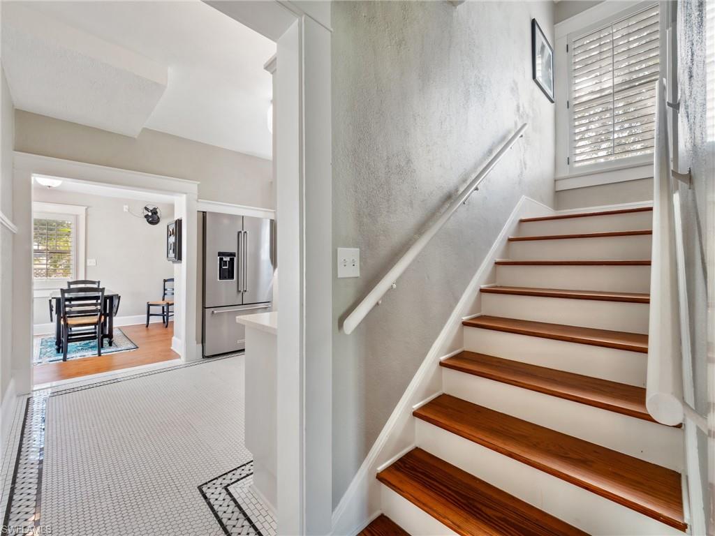 The beautifully preserved original staircase serves as a stunning centerpiece, showcasing the craftsmanship and attention to detail that defined homes built in the 1920s.