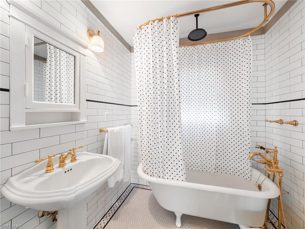 A true showpiece, the original clawfoot tub serves as a stunning reminder of the home's 1925 heritage.