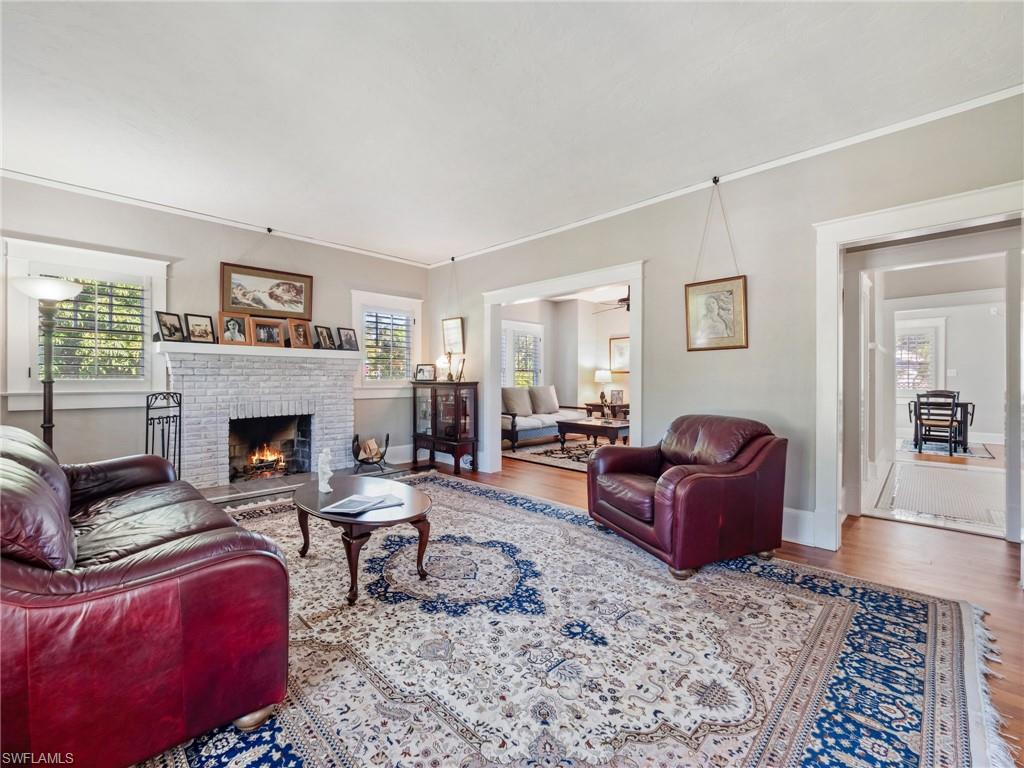 Gather around the warmth of the original wood-burning fireplace while enjoying beautifully preserved hardwood floors that have welcomed generations of family and friends.
