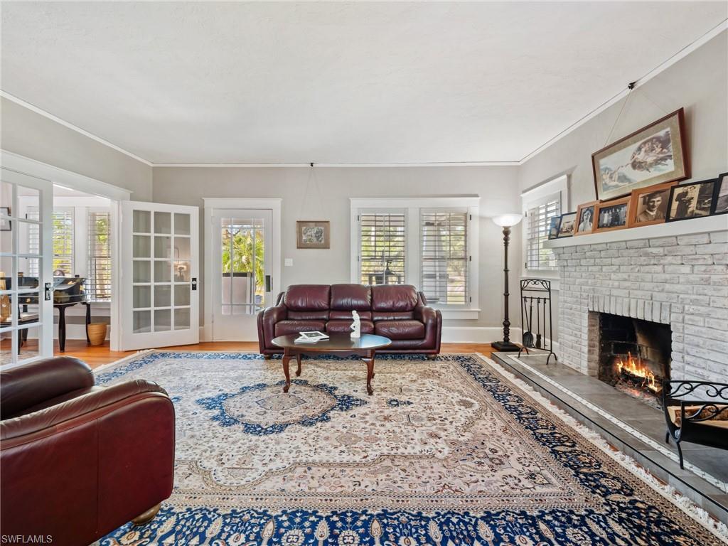 Rich in character and authenticity, this stunning space showcases original wood floors, historic architectural details, and a fully functional fireplace rarely found in homes today.