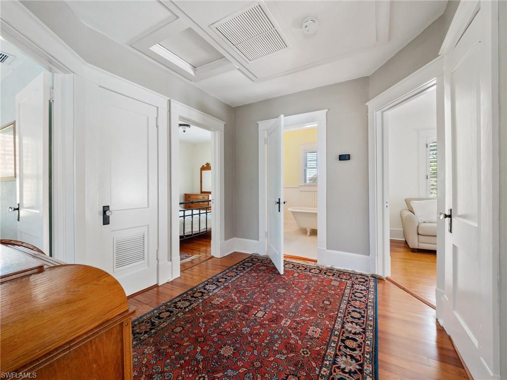 This cozy upstairs landing serves as a charming transition between the bedrooms and baths, complete with two convenient storage closets.