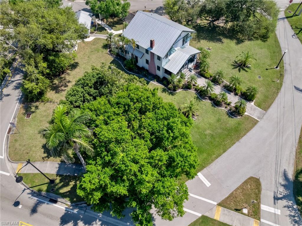 Aerial views showcase the home's impressive setting on its own historic block, surrounded by mature trees, charming architecture, and the character that defines Old Fort Myers.