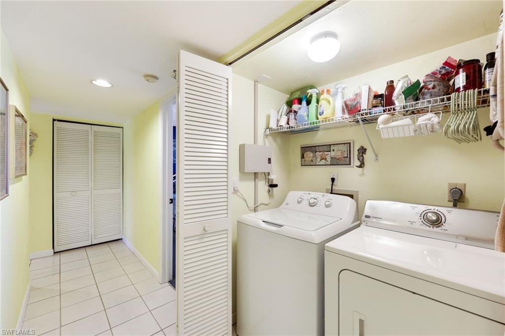 Laundry area with light tile patterned floors, baseboards, laundry area, recessed lighting, and independent washer and dryer