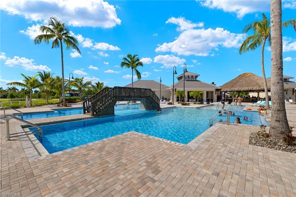 Pool featuring waterfall bridge and clubhouse