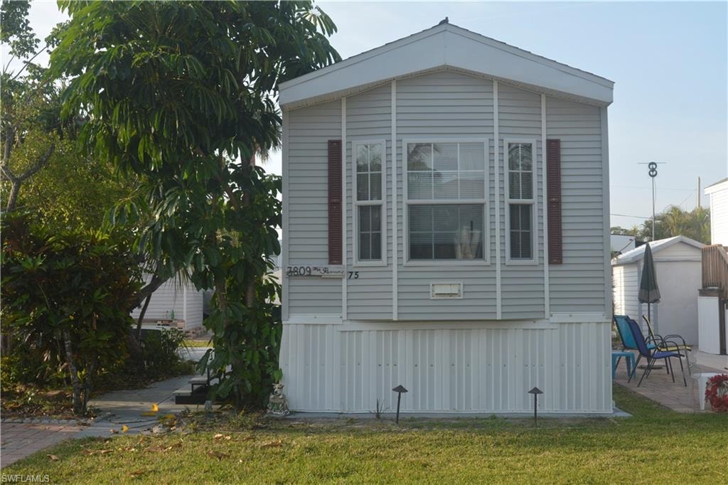 View of home's exterior featuring a lawn and a patio area
