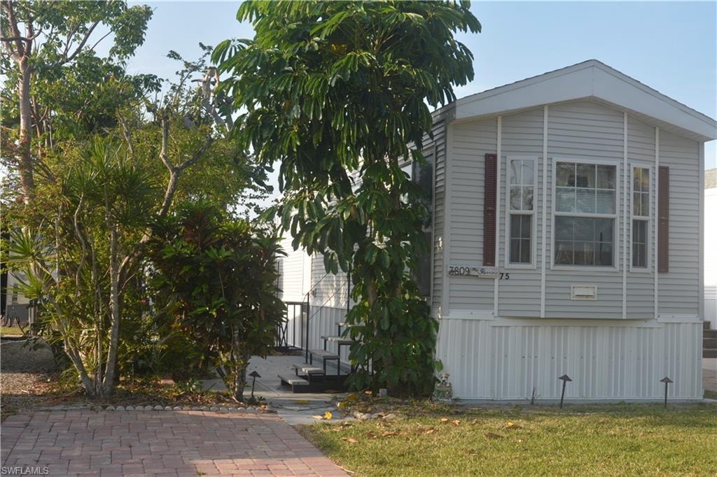 View of side of property with a yard