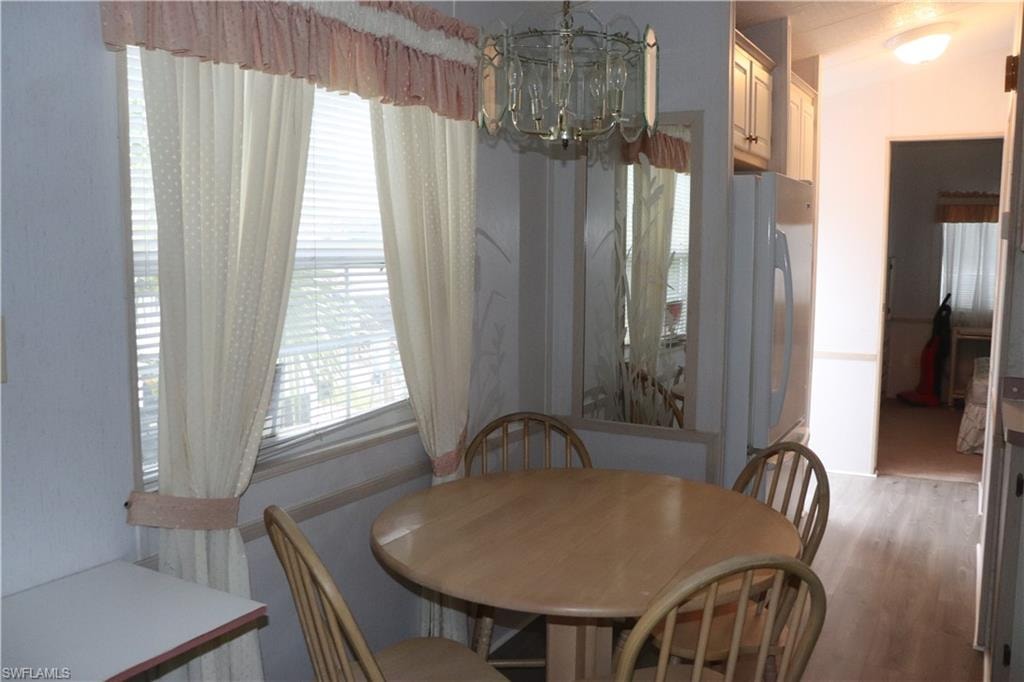 Dining space featuring an inviting chandelier and light wood-style floors