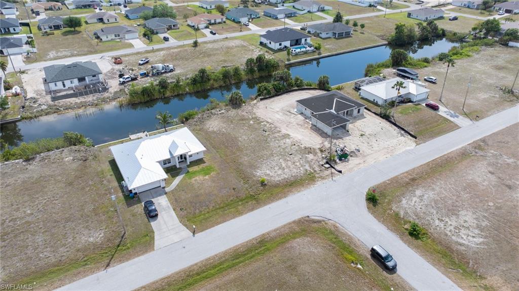 Aerial view with a water view and a residential view