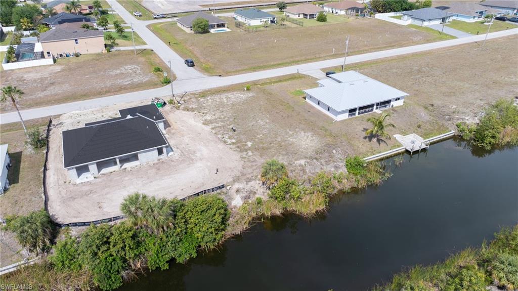 Bird's eye view with a water view and a residential view