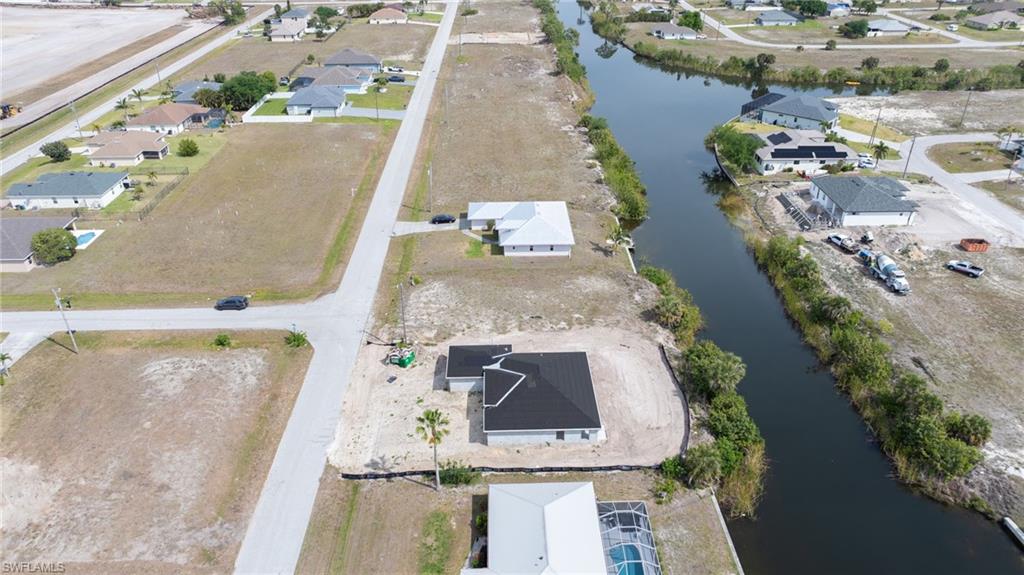 Drone / aerial view with a residential view and a water view