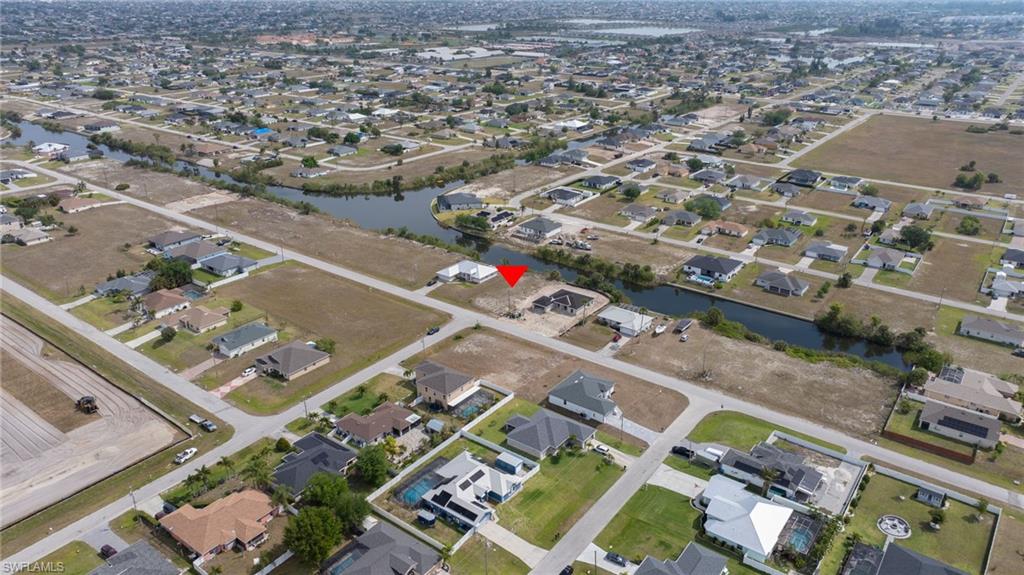 Birds eye view of property with a residential view and a water view