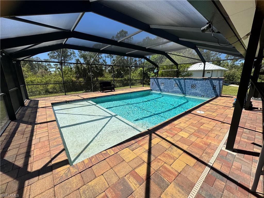 Pool featuring a lanai and a patio