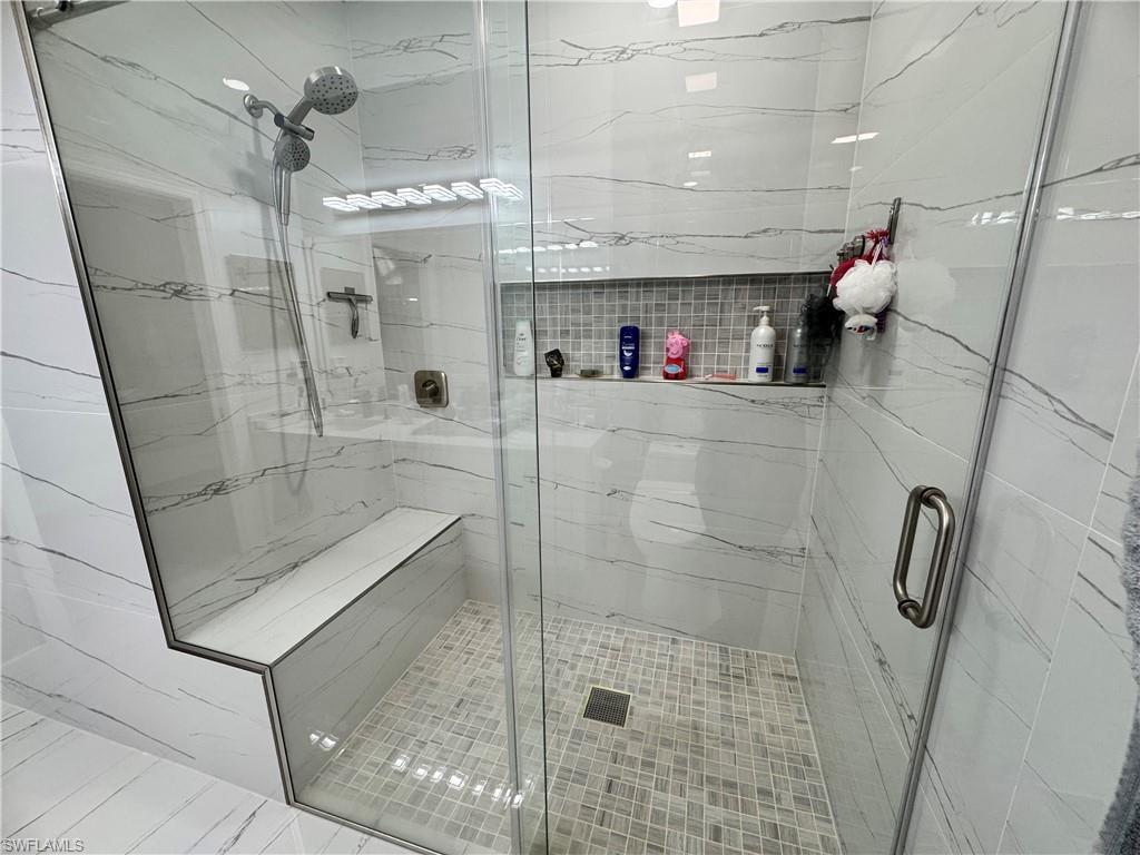 Full bathroom featuring a shower stall