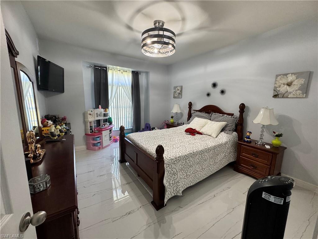 Bedroom with marble finish floor and baseboards