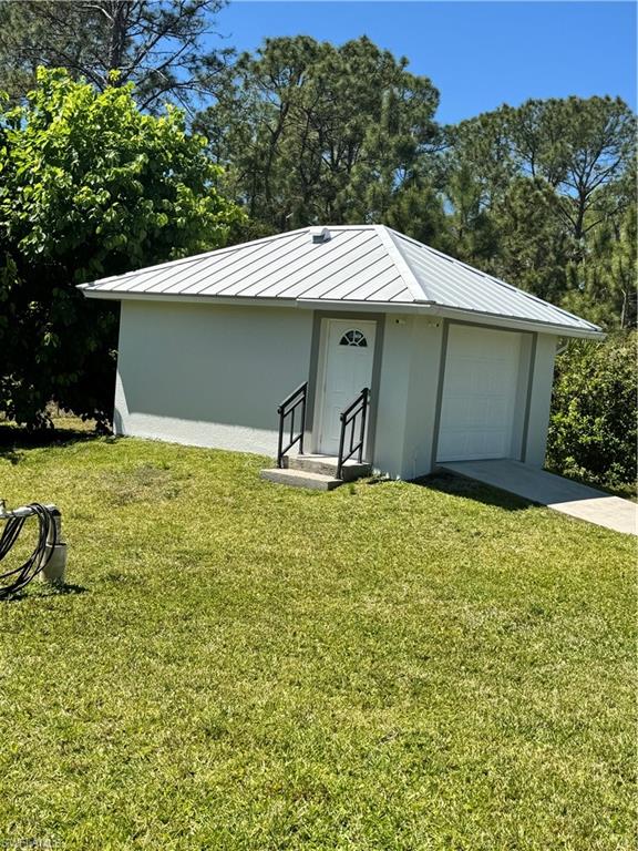 View of outdoor structure with a garage