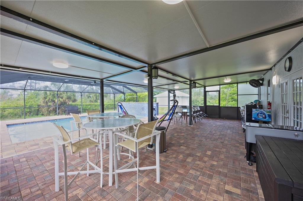Sunroom / solarium with outdoor dining space