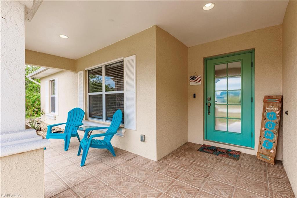 Entrance to property with stucco siding