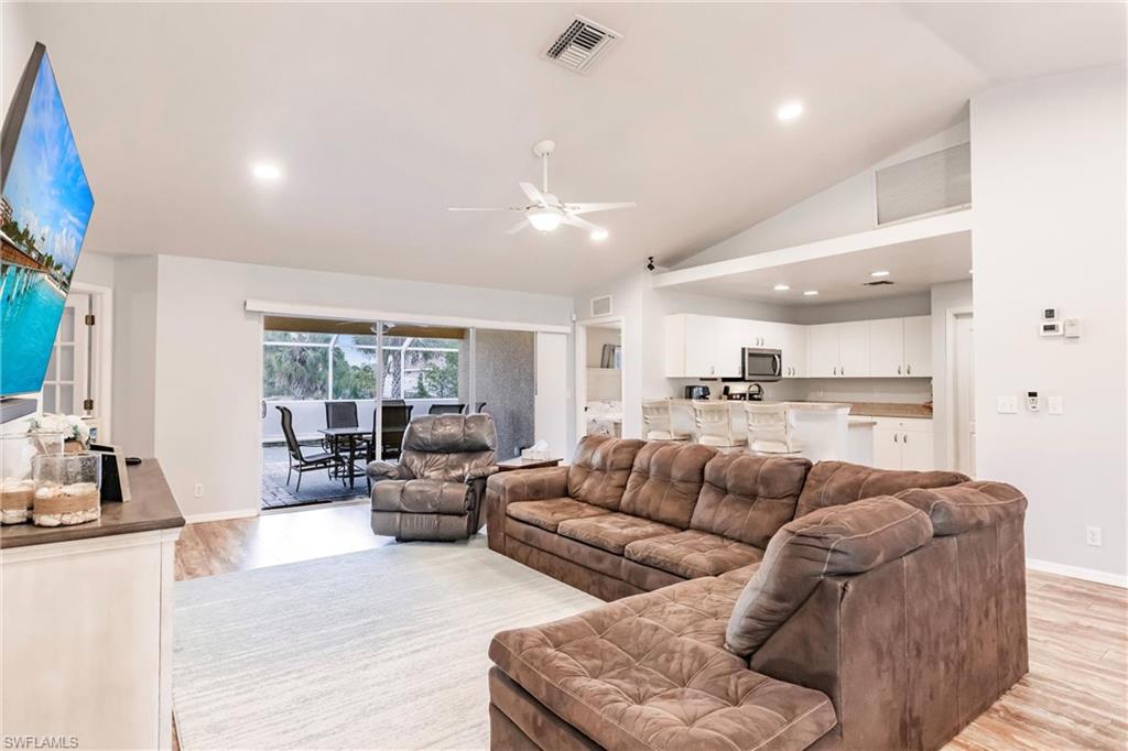 Living area featuring recessed lighting, open floor plan, light wood-style floors, and a ceiling fan