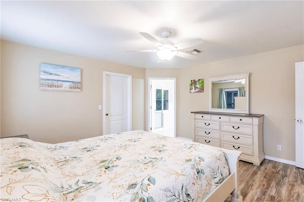 Bedroom featuring baseboards, laminate wood finished floors, and a ceiling fan