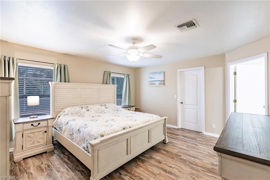 Bedroom with baseboards, light wood-style flooring, and a ceiling fan