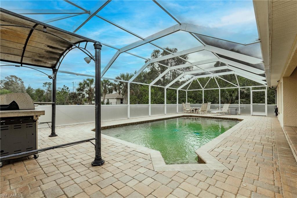 View of pool with a lanai, a patio, and a fenced in pool
