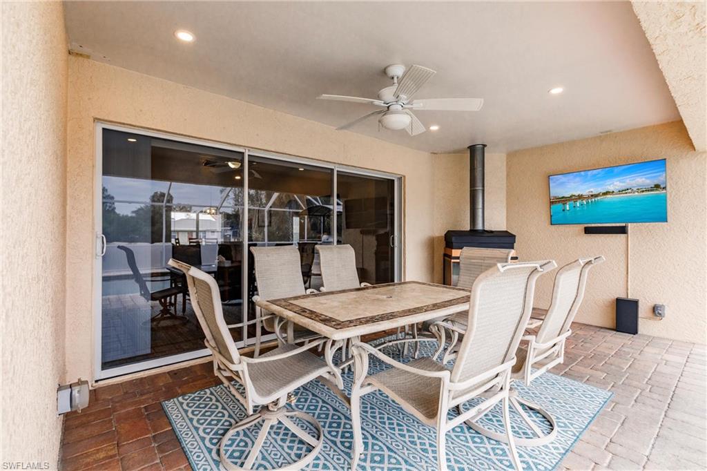 View of patio featuring outdoor dining space and ceiling fan