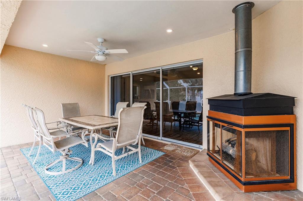 View of patio with a ceiling fan and outdoor dining space