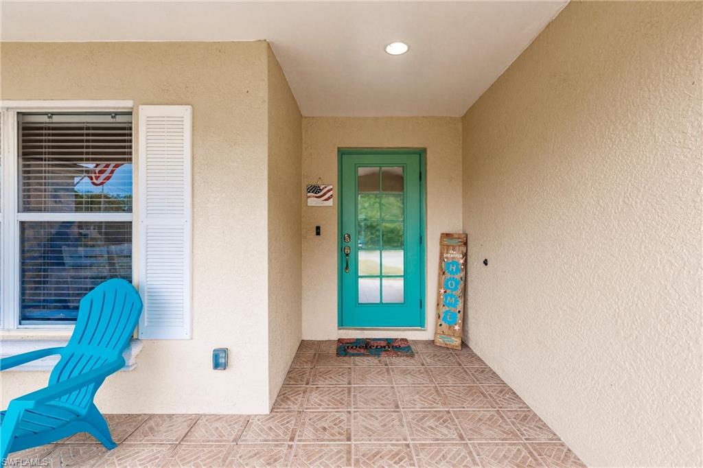 View of exterior entry with stucco siding
