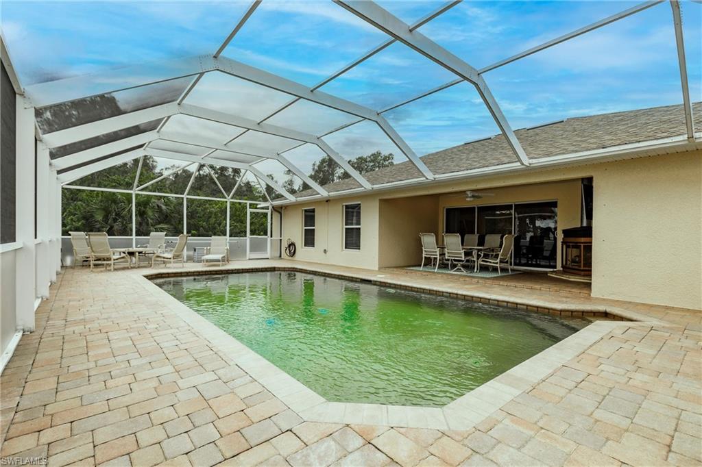View of swimming pool, outdoor dining area and extra lounge area